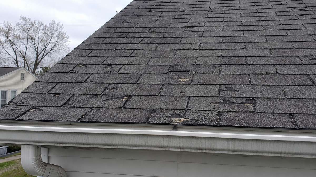 A worn asphalt shingle roof in Milwaukee showing signs of age