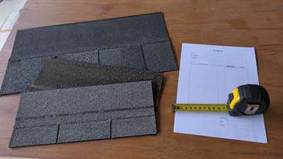 Asphalt shingle samples and a roof replacement cost estimate for a Milwaukee home